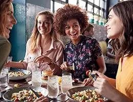 young of young adults eating at a restaurant